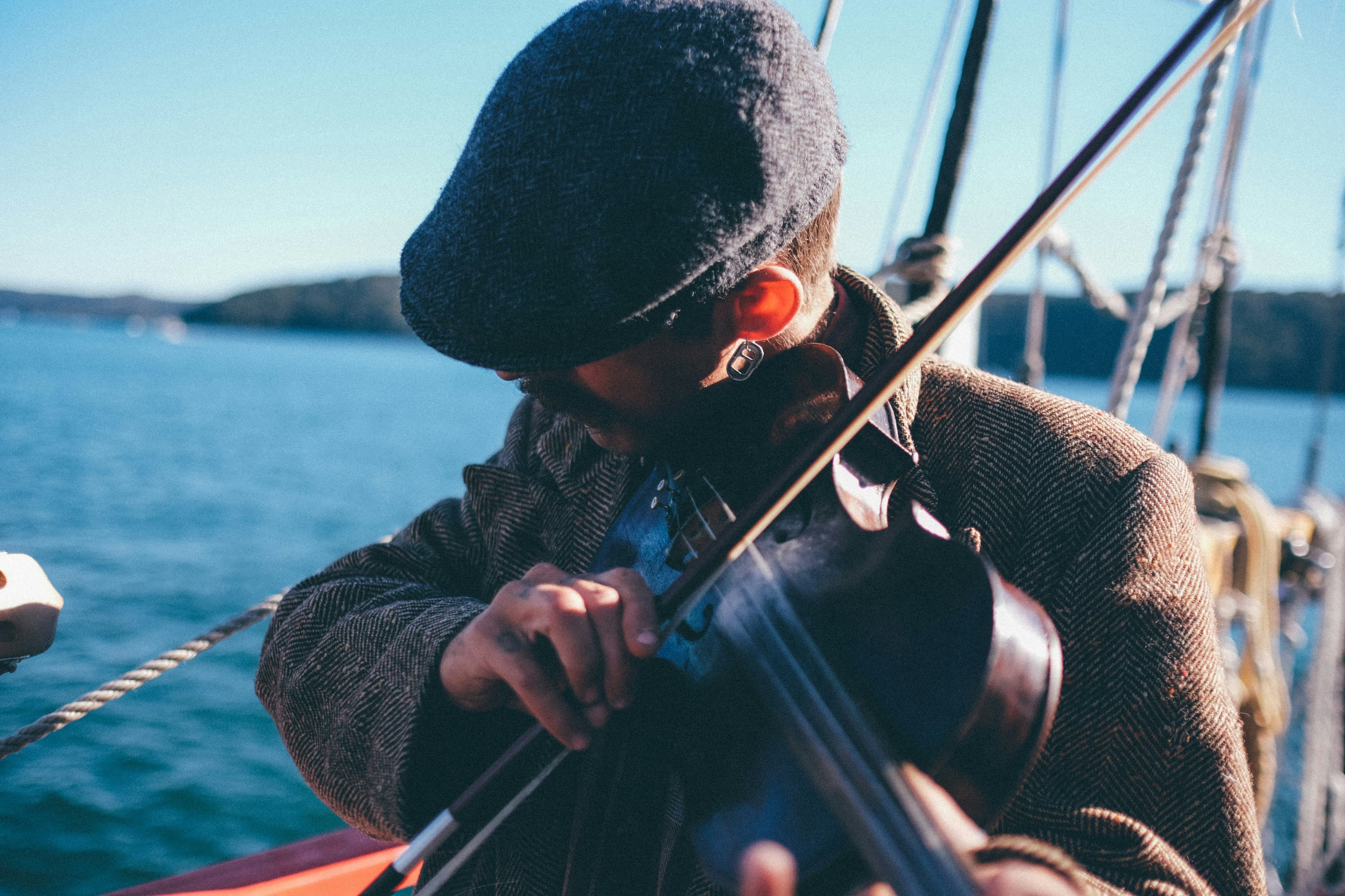 A person playing the fiddle on a fishing boat.